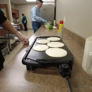 Team Leaders making pancakes and french toast for Team Members during DuraTech's annual Pancake Breakfast.